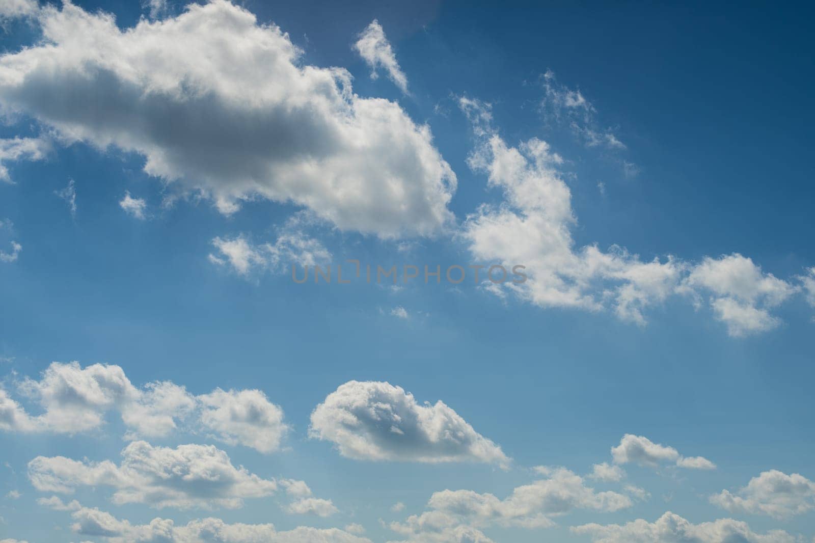 Blue summer sky white cumulus clouds background by zartarn