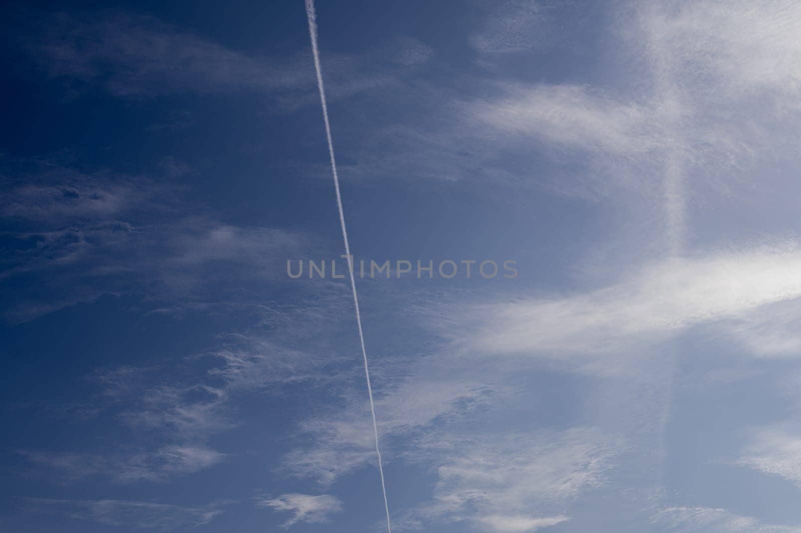 White spindrift clouds on blue sky, background - image