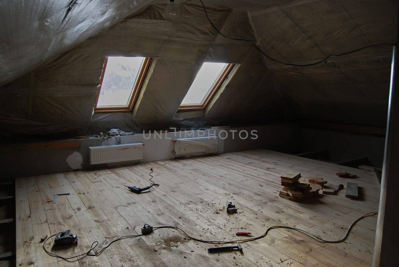 Insulating the room and laying floorboards.