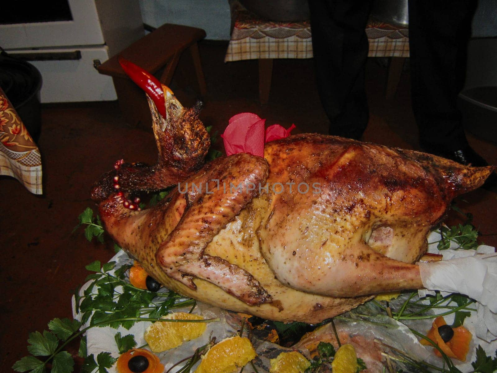 Beautifully decorated turkey with red pepper in its beak.