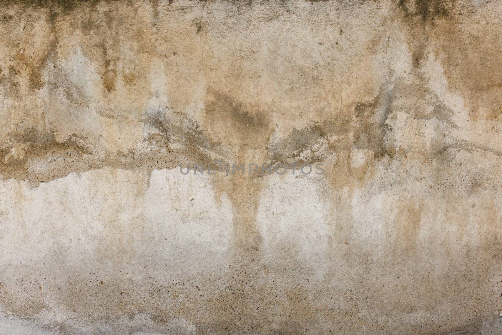 Old water damaged grey plaster wall surface with yellow smudges. Full-frame flat background and texture.