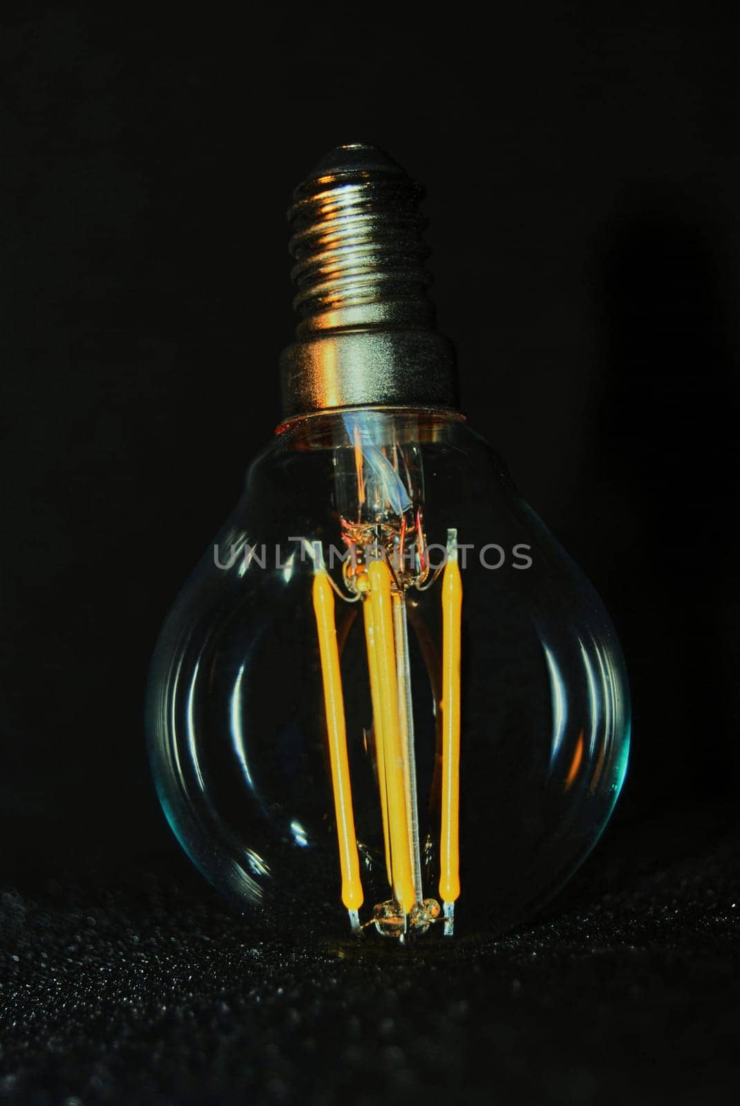 Decorative light bulb with yellow spirals.