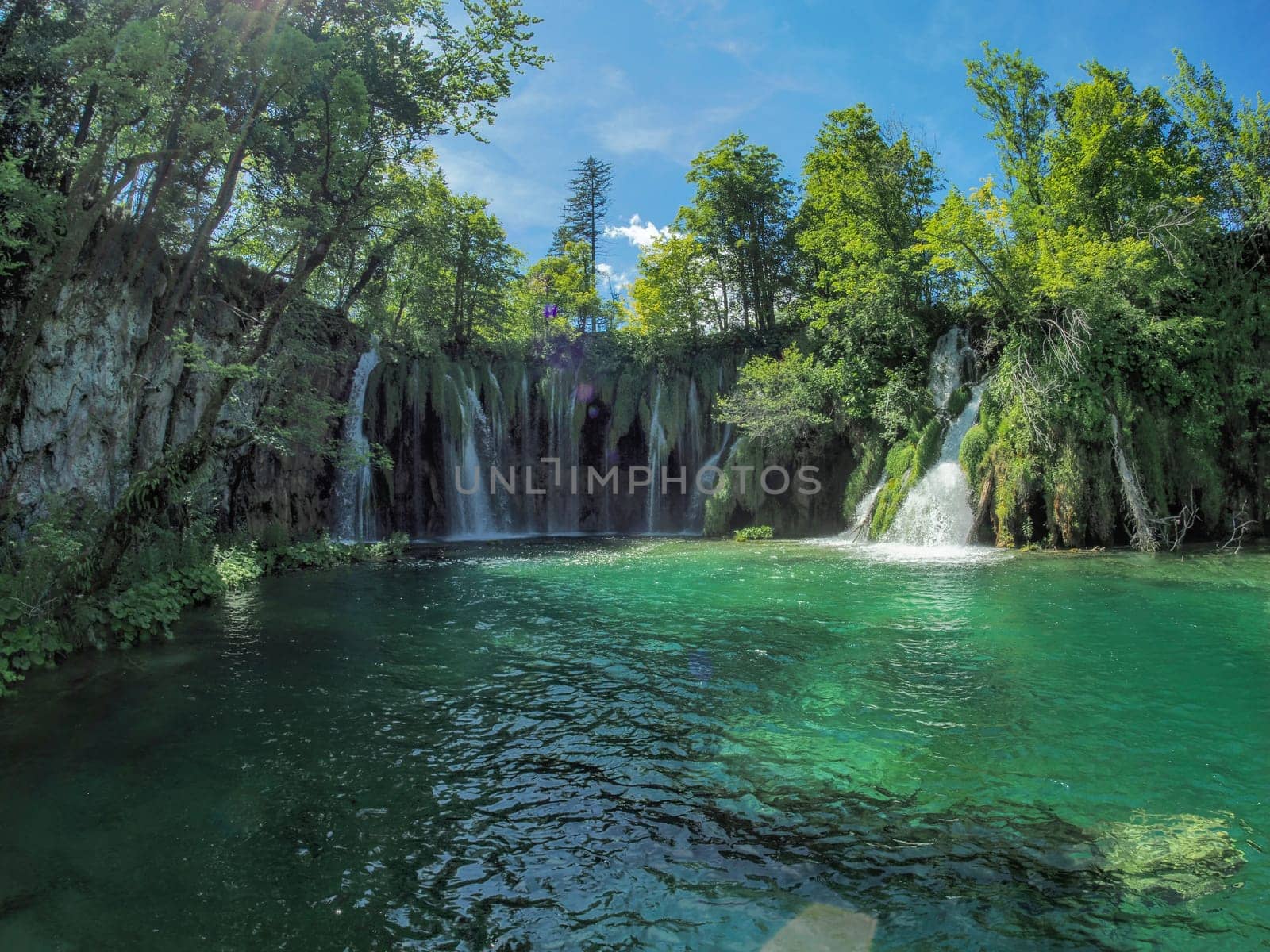 Summer view of water lakes and beautiful waterfalls in Plitvice Lakes National Park, Croatia by AndreaIzzotti