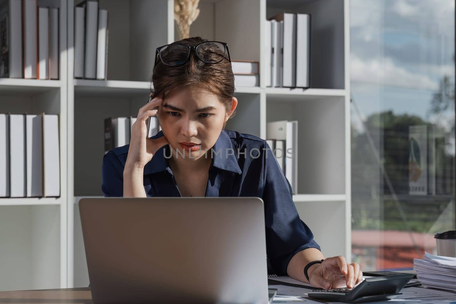 The accountant is stressed while calculating the mismatched taxes and finances..