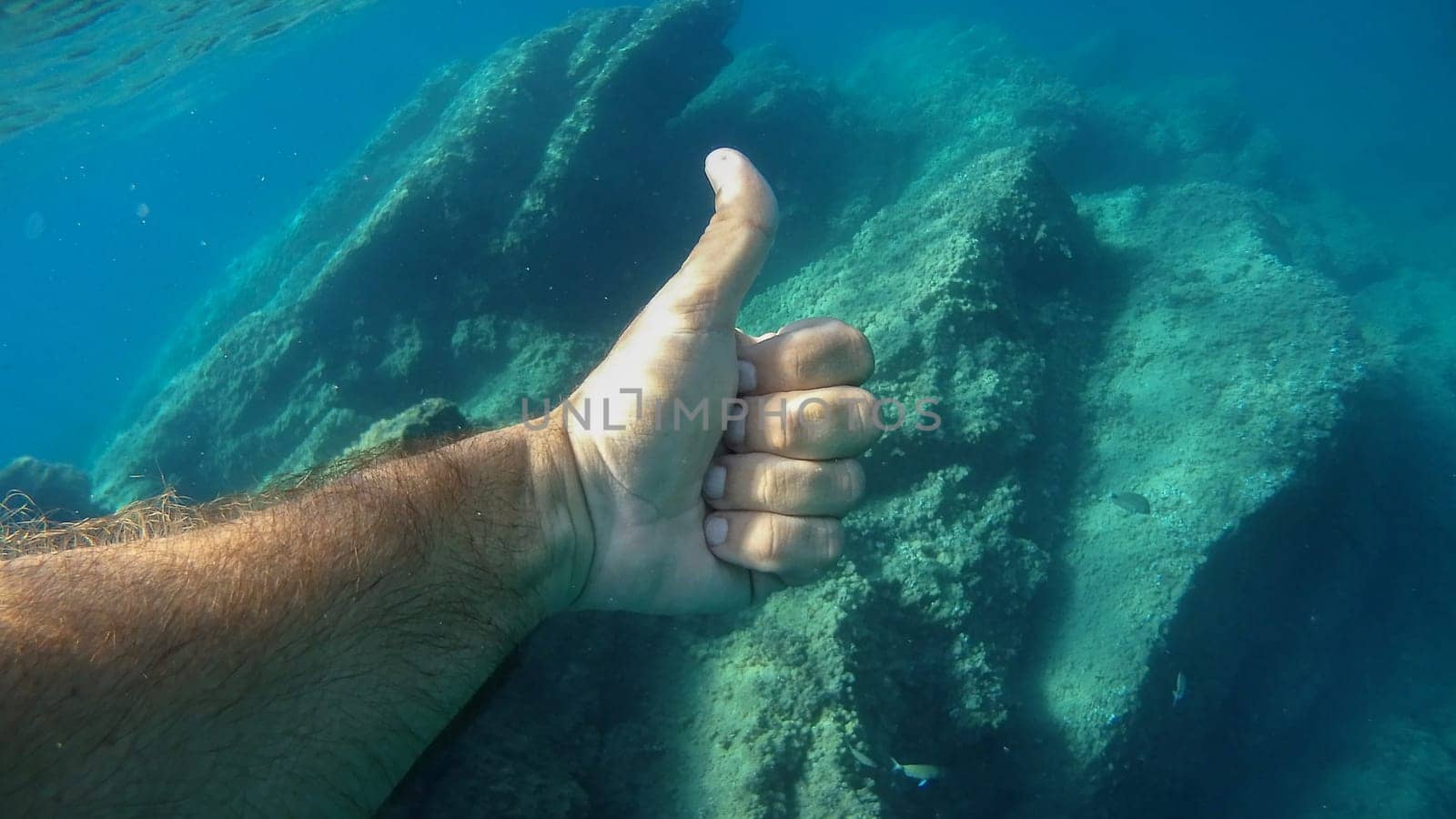 thumb up ok human hand underwater detail close up