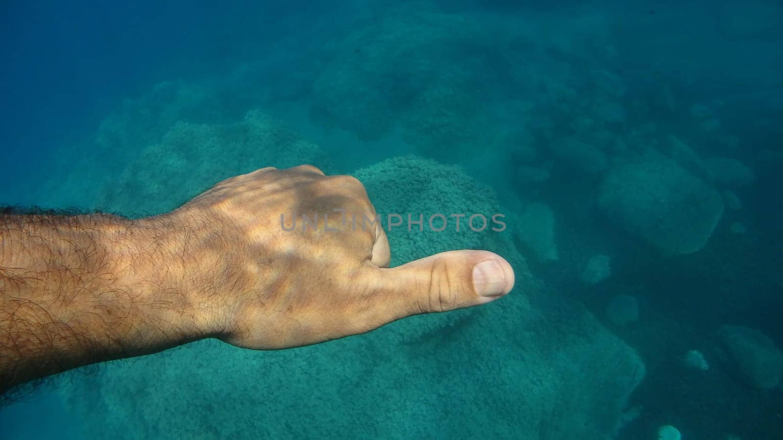 thumb up ok human hand underwater detail by AndreaIzzotti