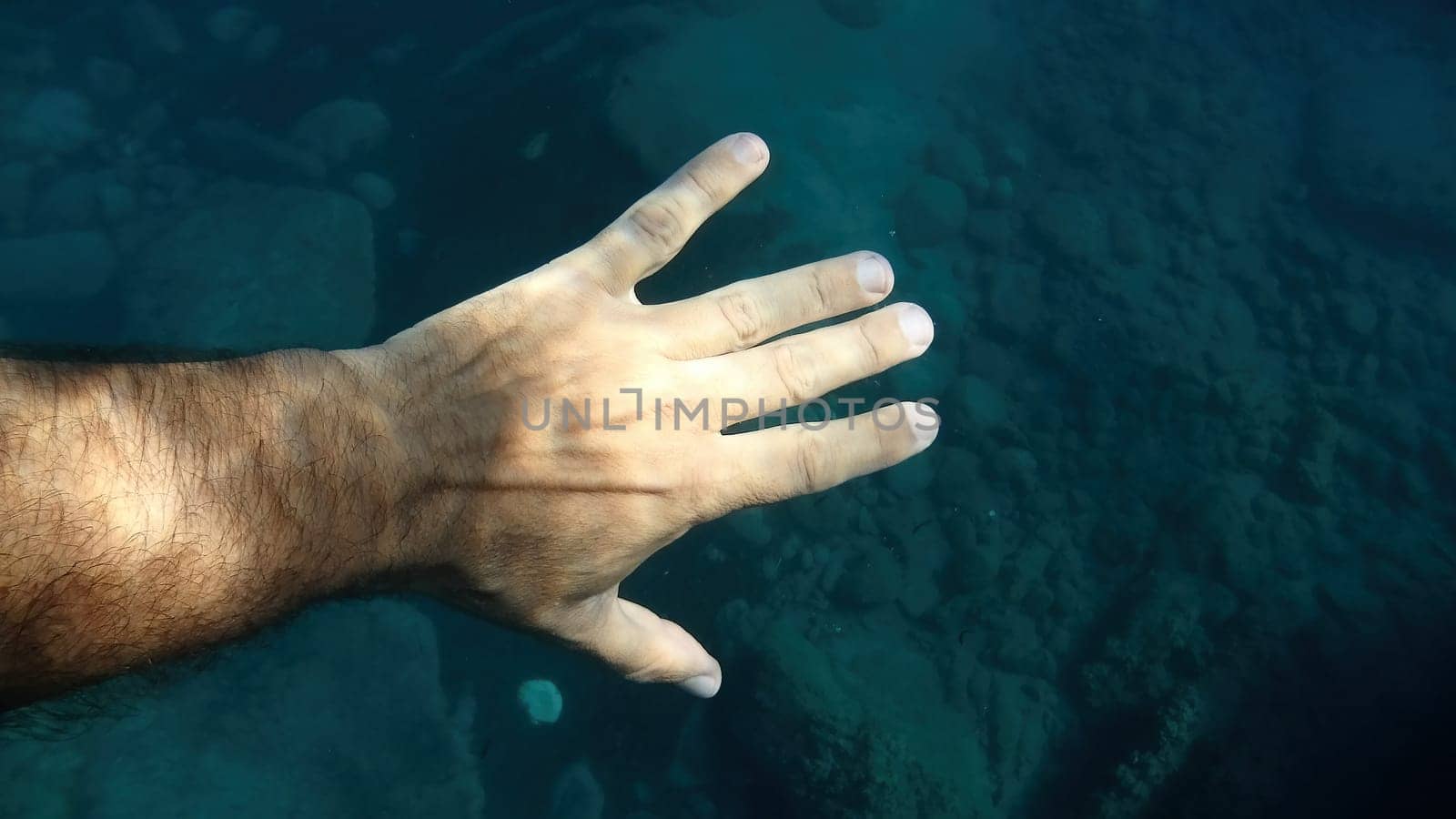 open palm human hand underwater detail close up