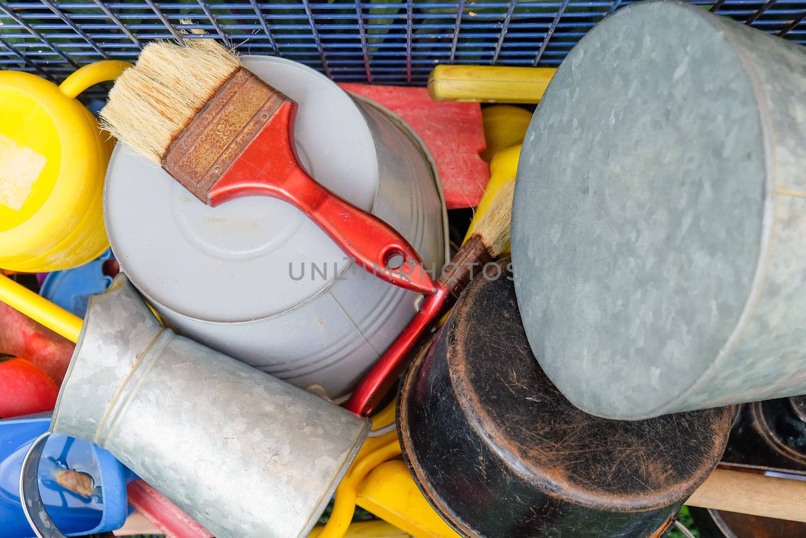 Colorful array of common household items and tools in a disorganized arrangement by ponsulak