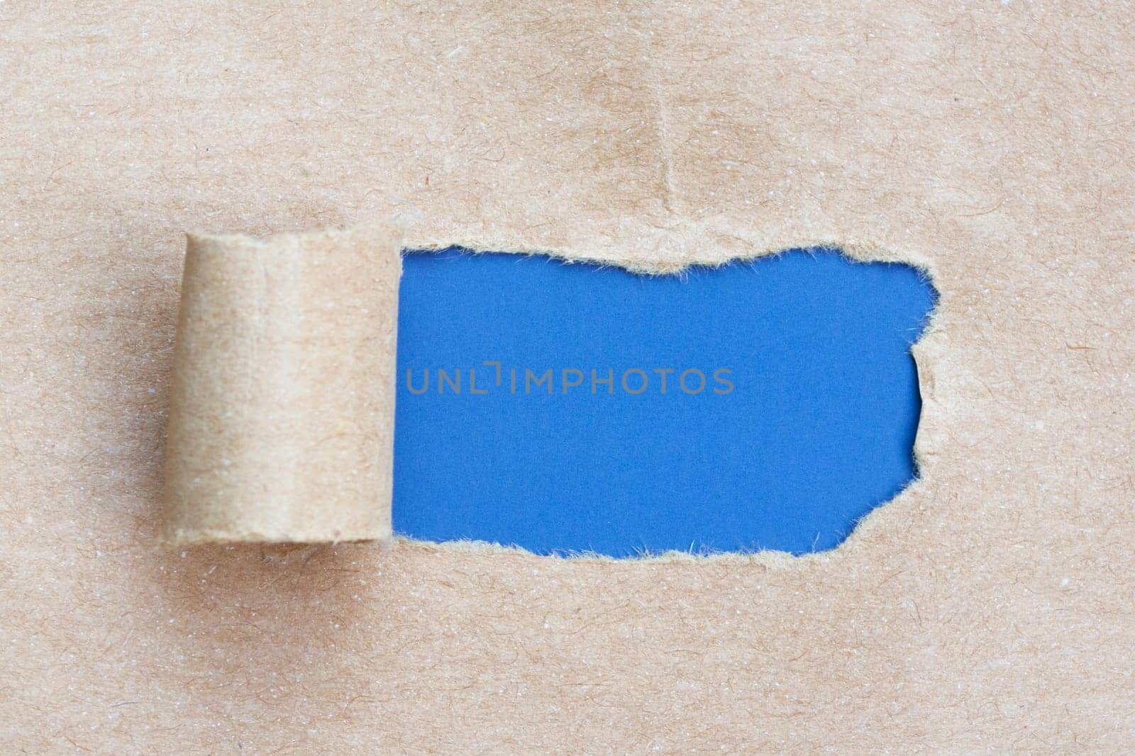 Brown torn paper with blue background. by JennMiranda