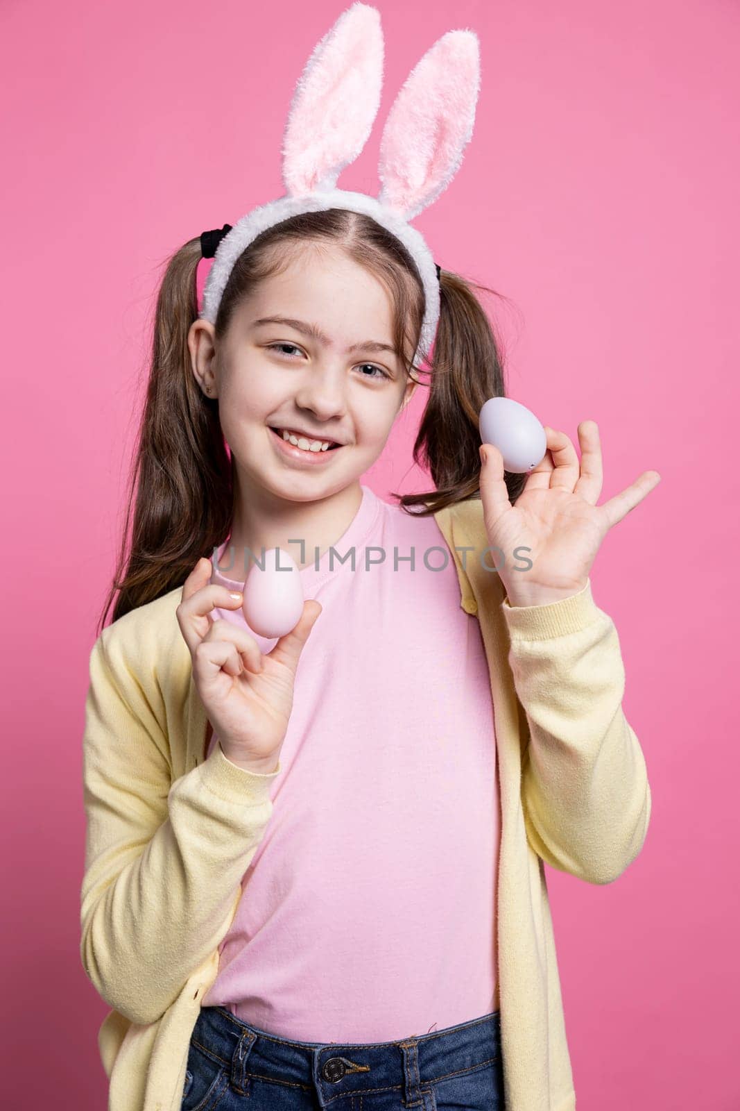 Young cute girl posing with confidence in front of camera by DCStudio
