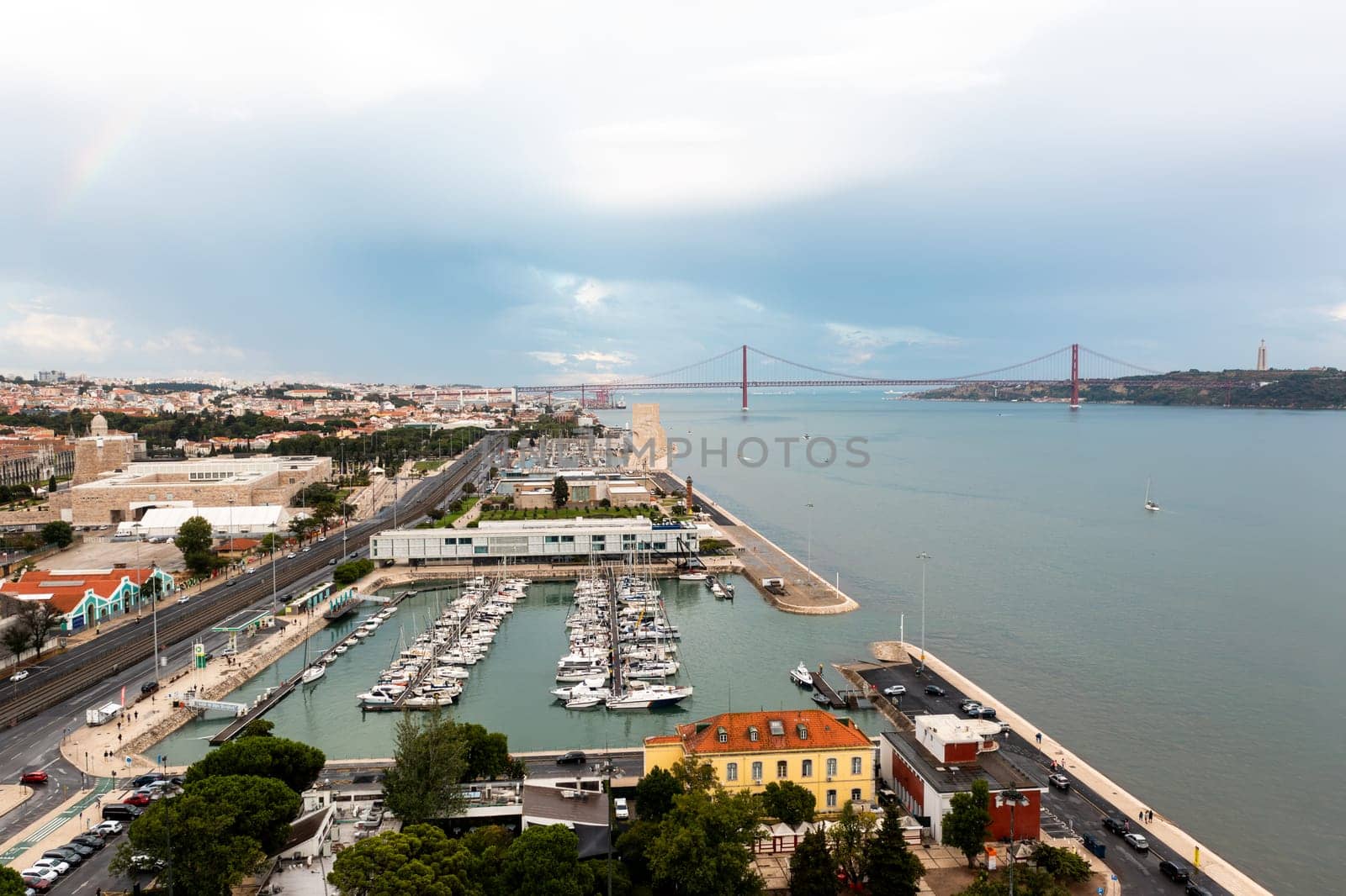 Yacht parking on the coast of the Atlantic Ocean in the suburbs of Lisbon, Portugal. Marina in Belem. Vasco da Gama bridge on background