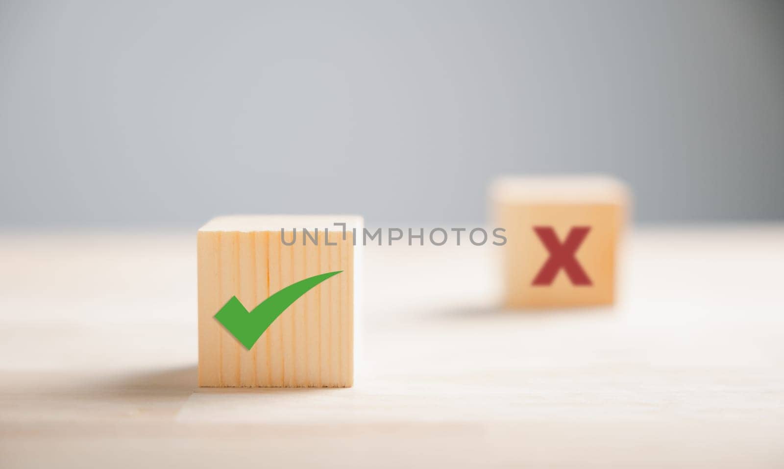 Wooden block exhibits green check mark and red x representing decision-making. Choice concept displayed. Think With Yes Or No Choice. by Sorapop