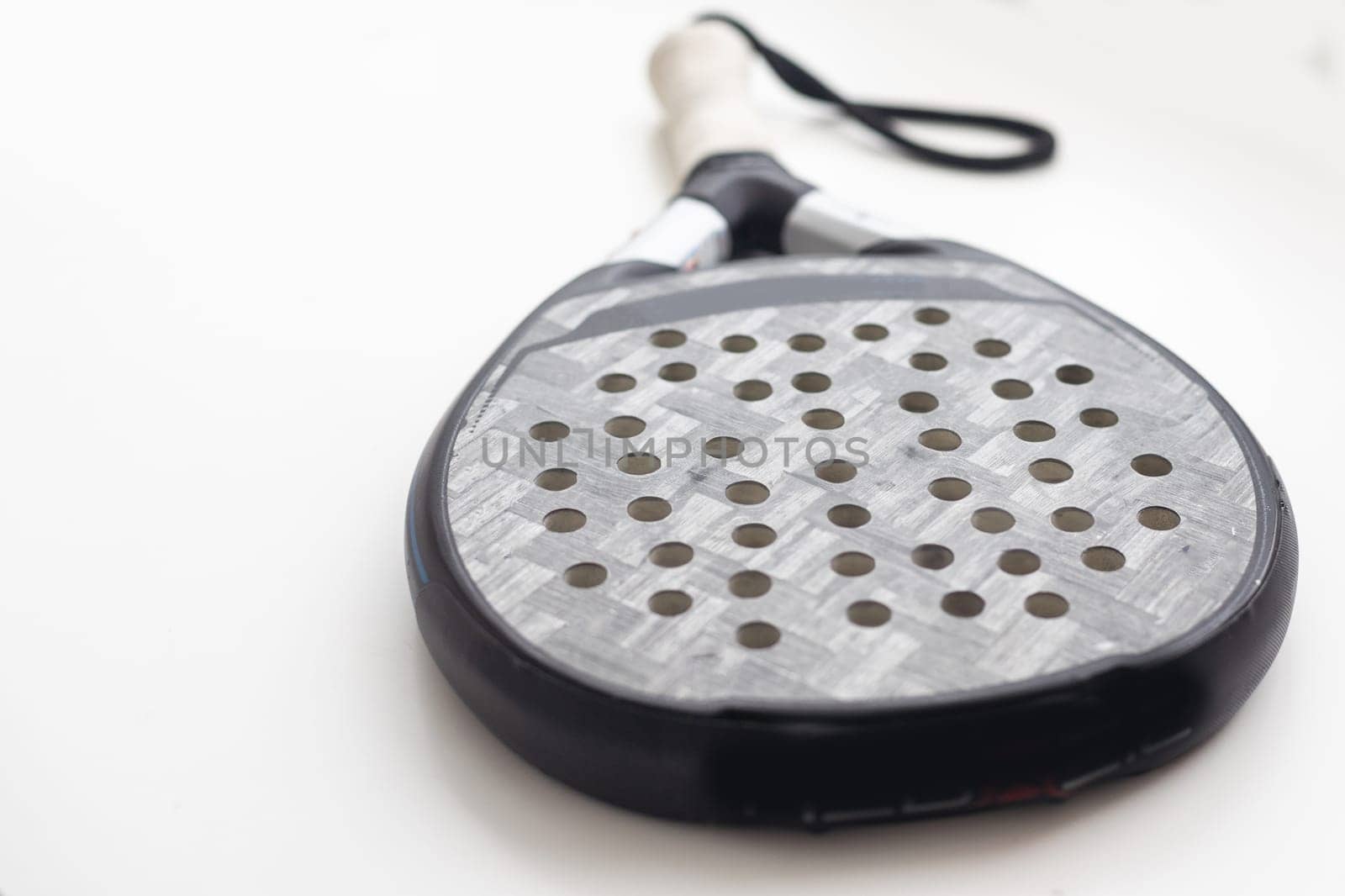 blue professional paddle tennis racket isolated on white background. portrait sport theme poster, greeting cards, headers, website and app. High quality photo