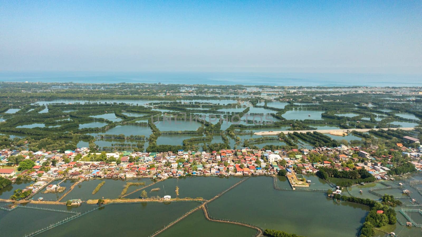 Aerial view of Aquaculture farm and village in the countryside of the Philippines.