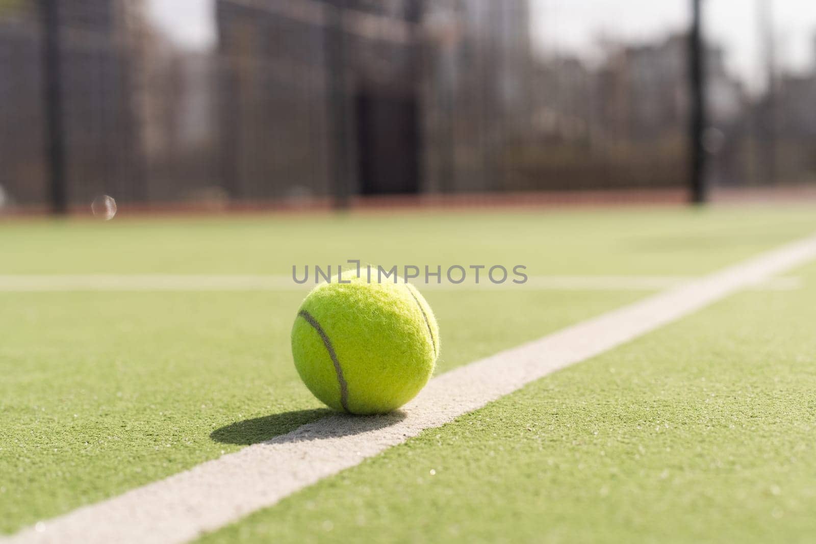 Tennis ball on a tennis court next to the side line. High quality photo
