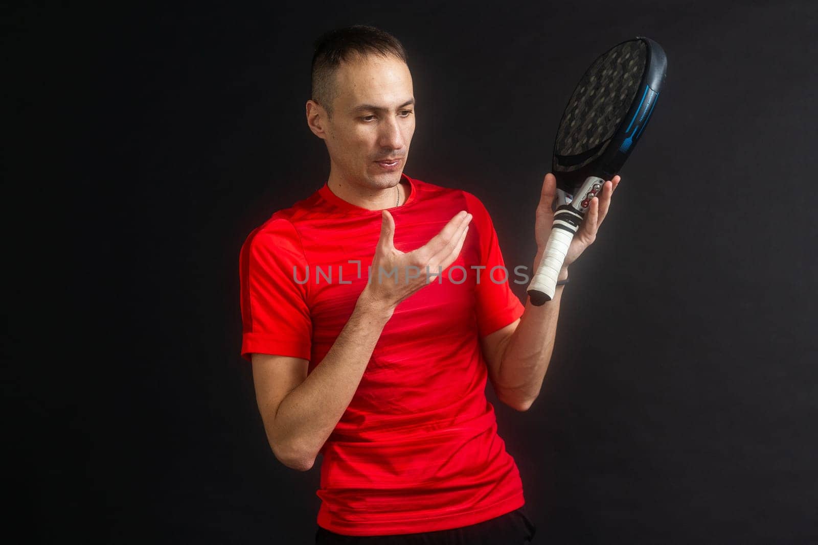 Paddle tennis: Man, Player with hand and Paddel racket and ball . High quality photo