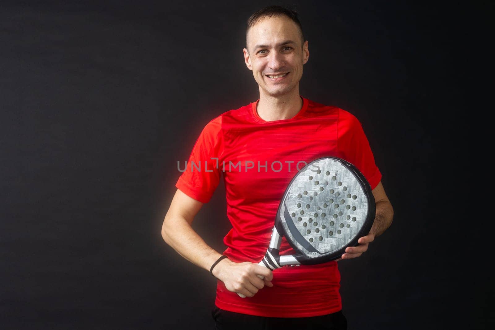 Paddle tennis: Man, Player with hand and Paddel racket and ball . High quality photo
