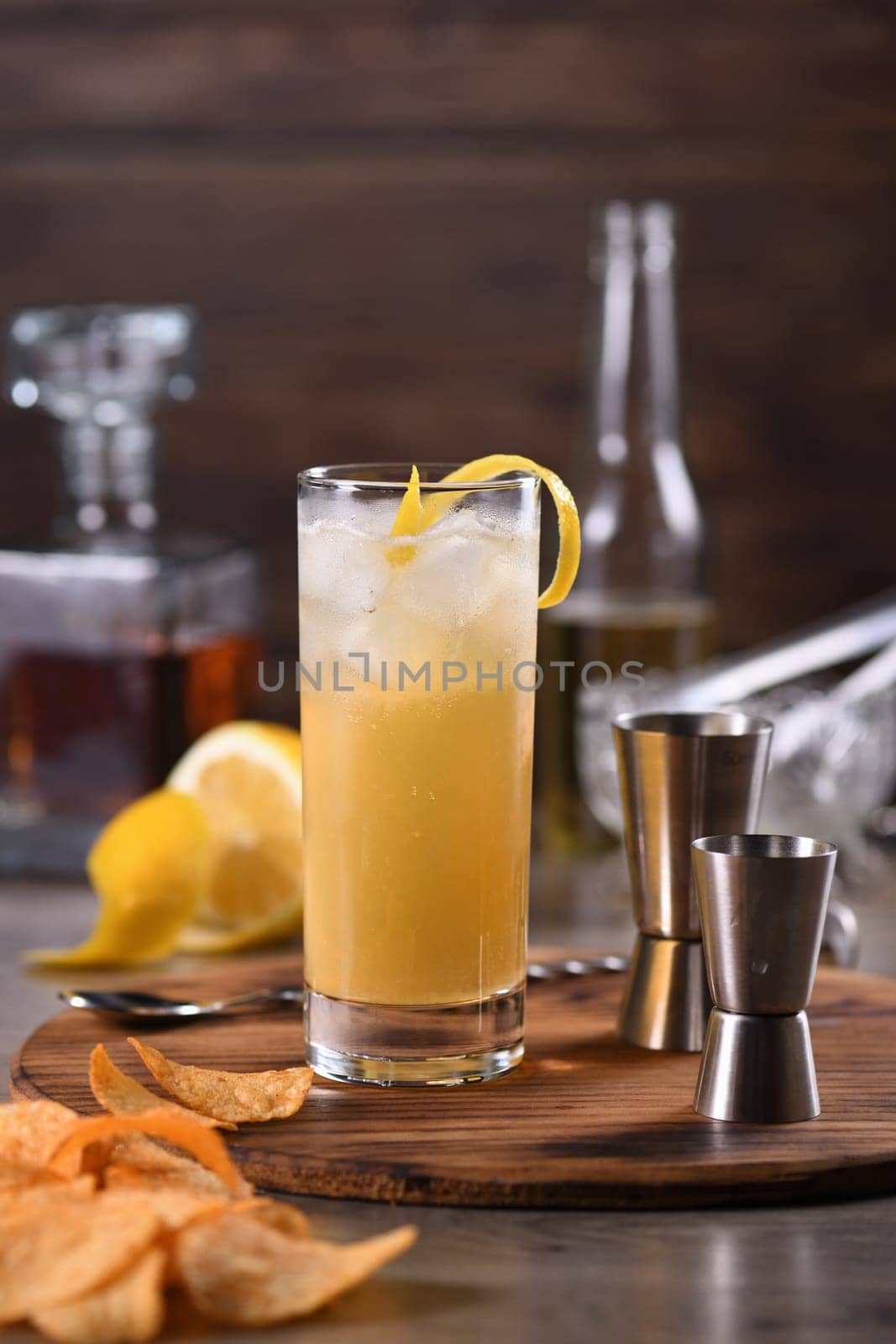  Whiskey cocktail with ginger beer, garnished with lemon zest