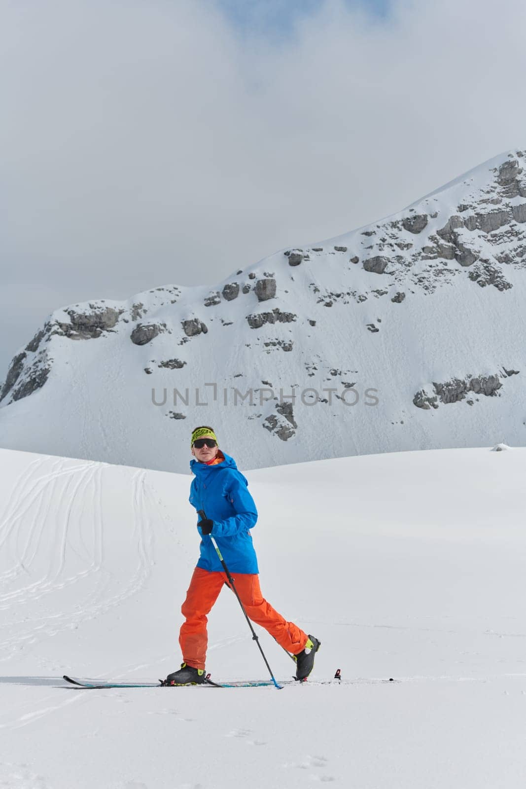 A Skier Scales a Treacherous Alpine Peak by dotshock