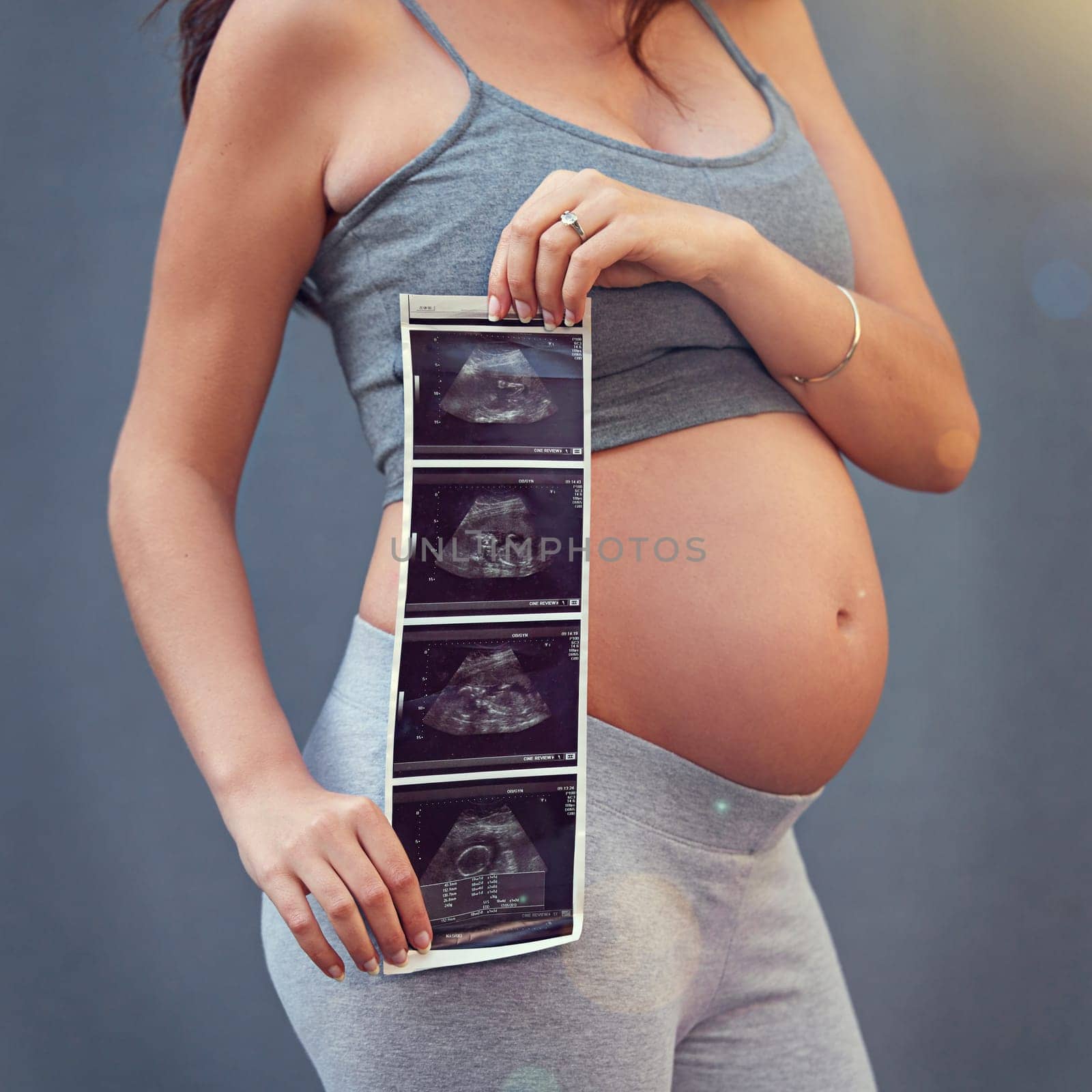 Mother, pregnancy and ultrasound in studio with belly for gender reveal, album and baby shower. Woman, child and sonogram isolated on gray background for maternity shoot, surrogacy and adoption.