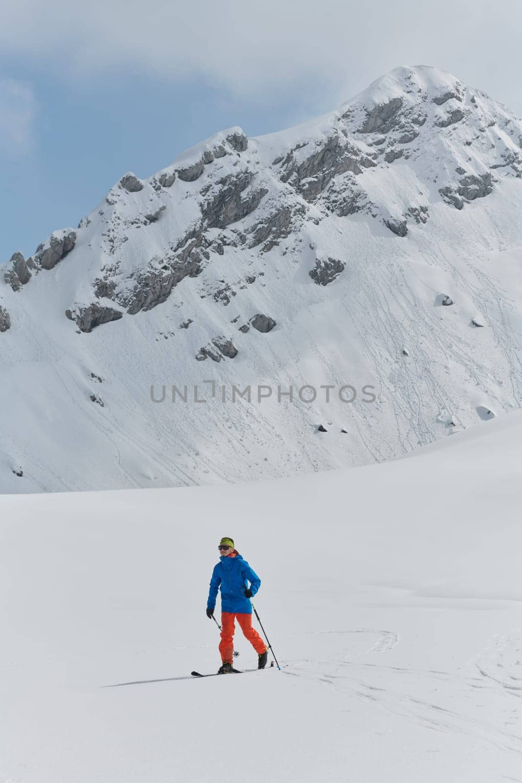 A Skier Scales a Treacherous Alpine Peak by dotshock