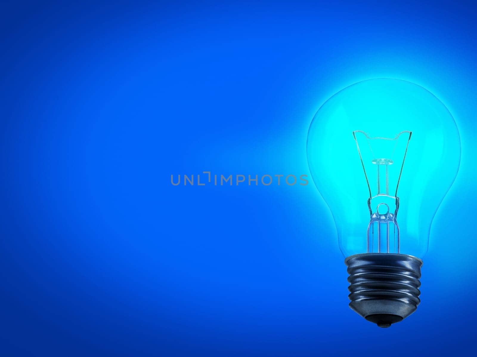 Lightbulb, energy and electricity in studio for idea with mockup space for inspiration, solution or genius thought. Power, glow light and science for knowledge or creative thinking on blue background.
