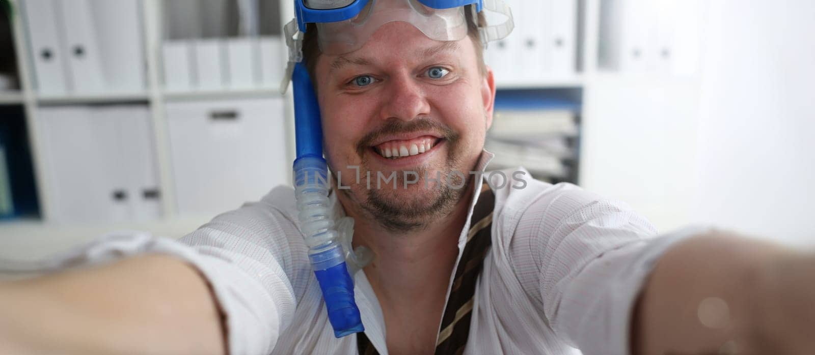 Man wearing suit and tie in goggles and snorkel make selfie with cellphone at office ready to take off portrait. Count days to leave annual day off workaholic freedom fun tourism resort idea concept