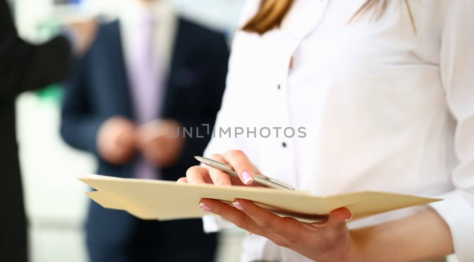 Female arm in shirt hold silver pen and pad making note in office closeup. Deal consult delivery signature financial inspector job fill survey form discuss strategy project negotiation concept