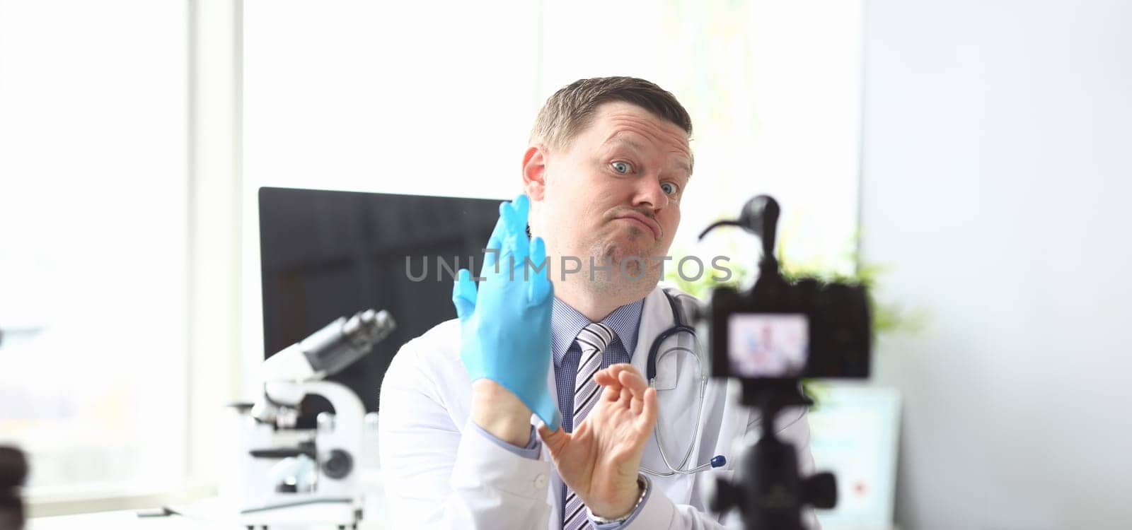 Male doctor pull on hand blue protective by kuprevich