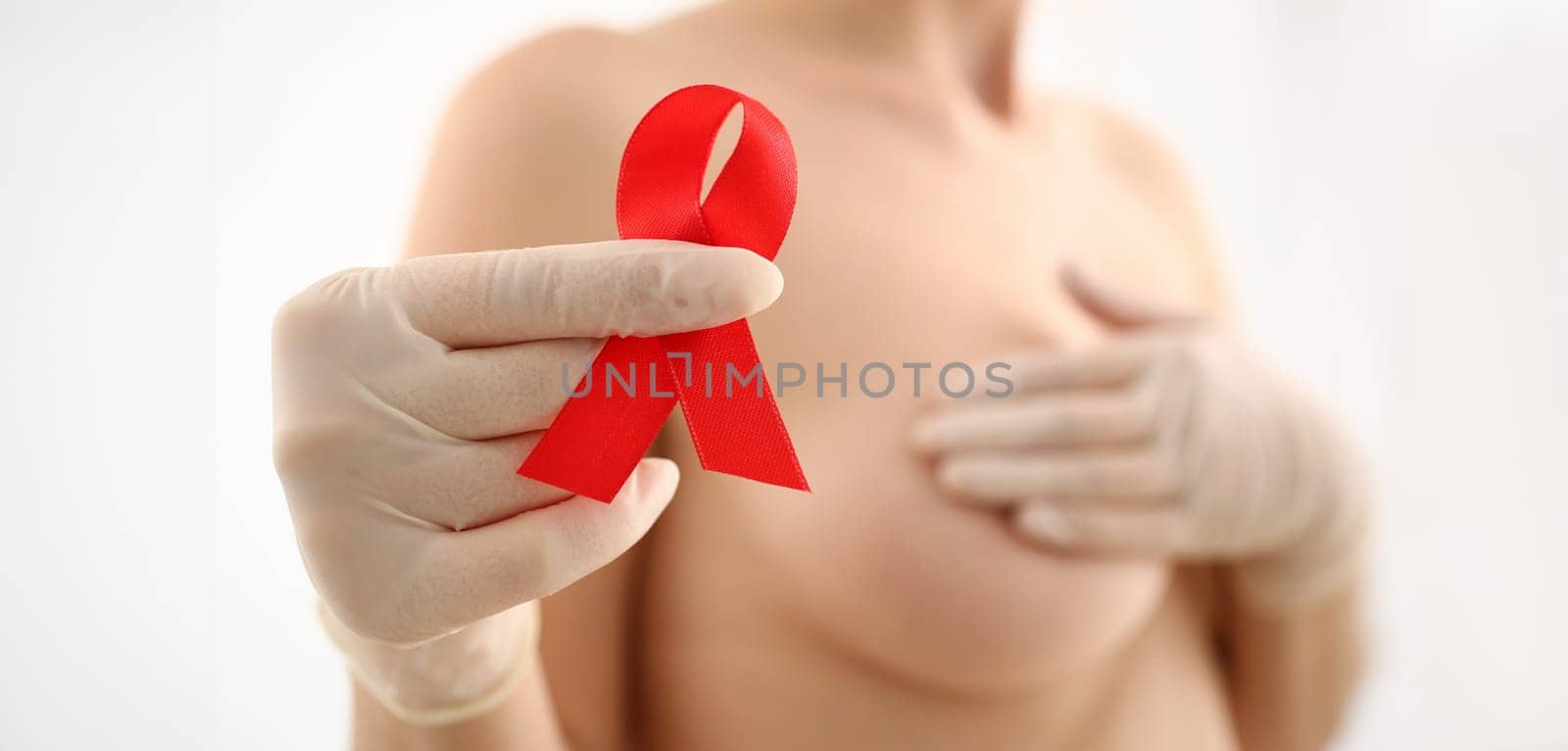 Female hand in gloves holding breast closeup by kuprevich