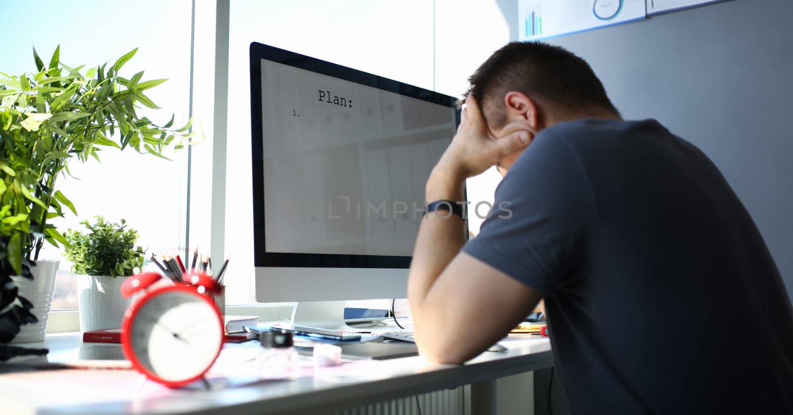 Sad upset male worker hold his head solving business problem by kuprevich