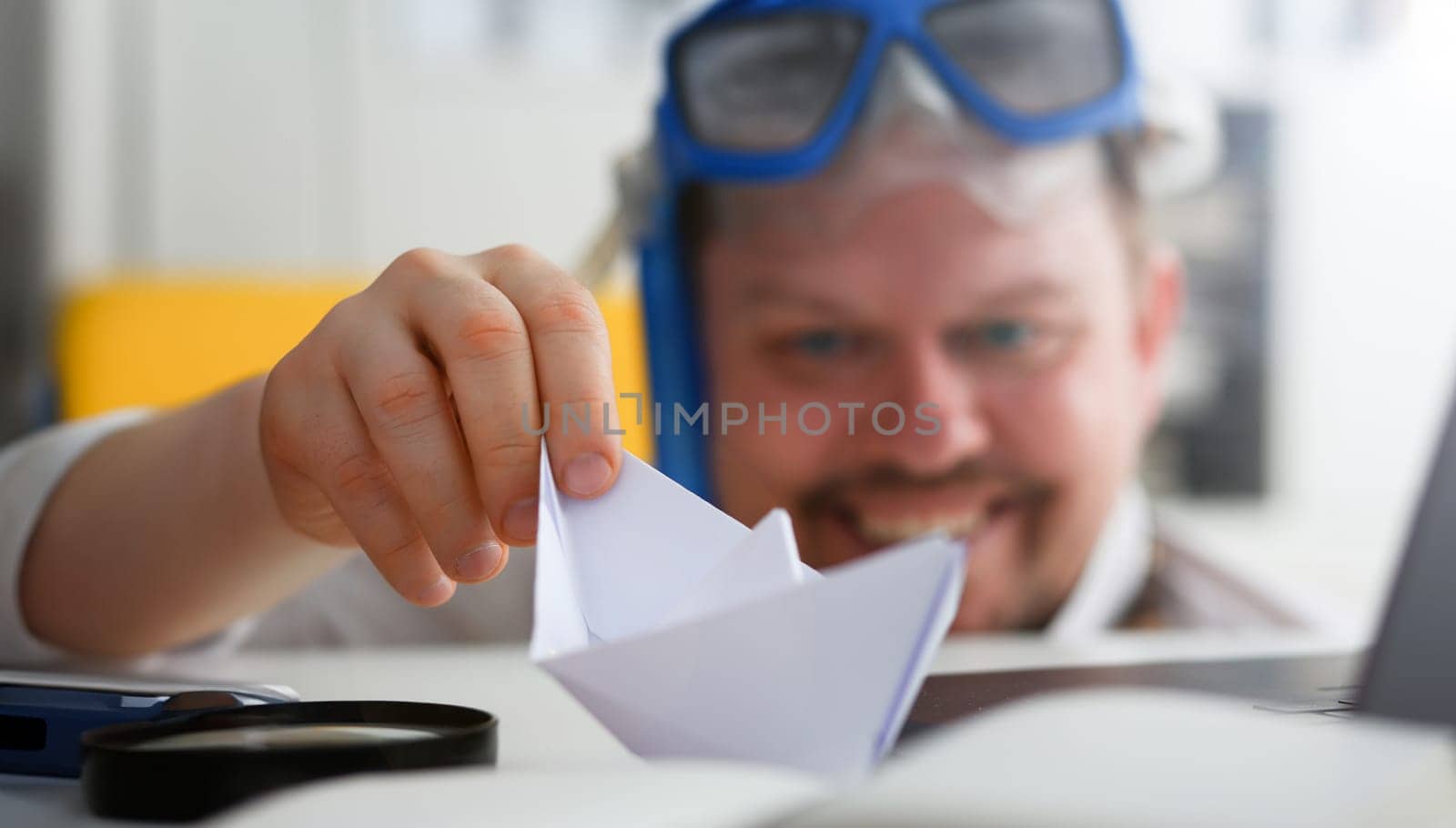 Man wearing suit and tie in goggles and snorkel play with paper ship in office closeup. Count days to leave annual day off workaholic freedom fun tourism resort idea ticket sale concept