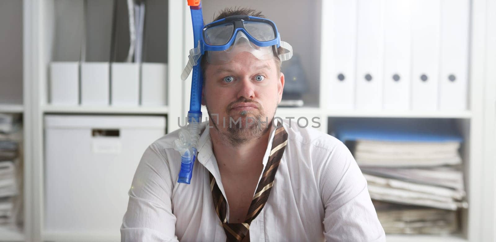 Man wearing suit and tie in goggles with snorkel by kuprevich