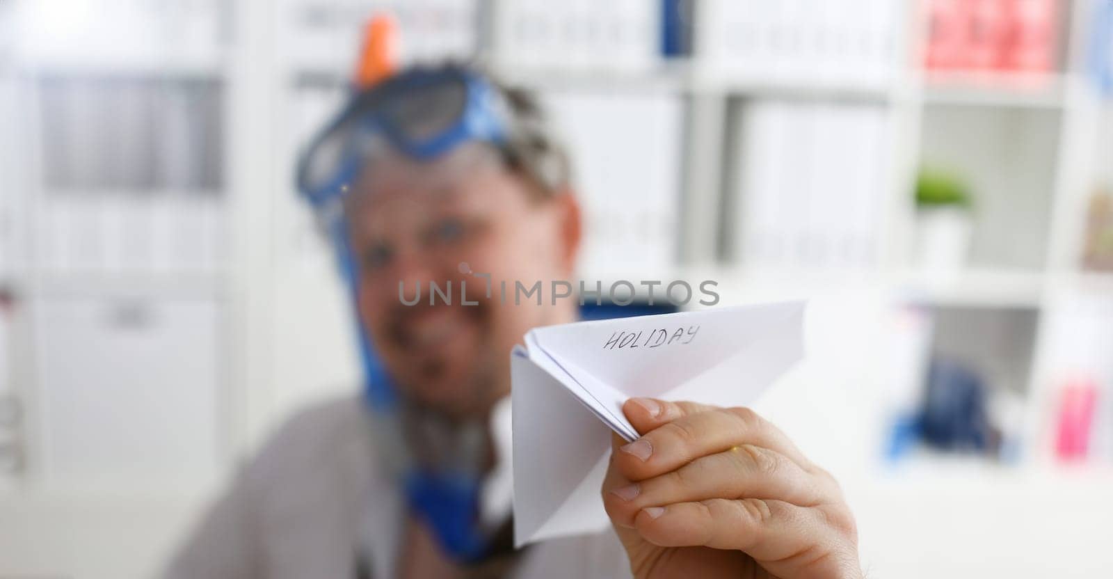 Man wearing suit and tie in goggle and snorkel play with fly papers plane in office closeup. Count days to leave annual day off workaholic freedom fun tourism resort idea ticket sale overseas concept