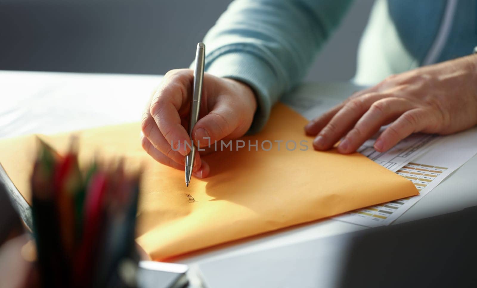 Male hand holding silver pen by kuprevich