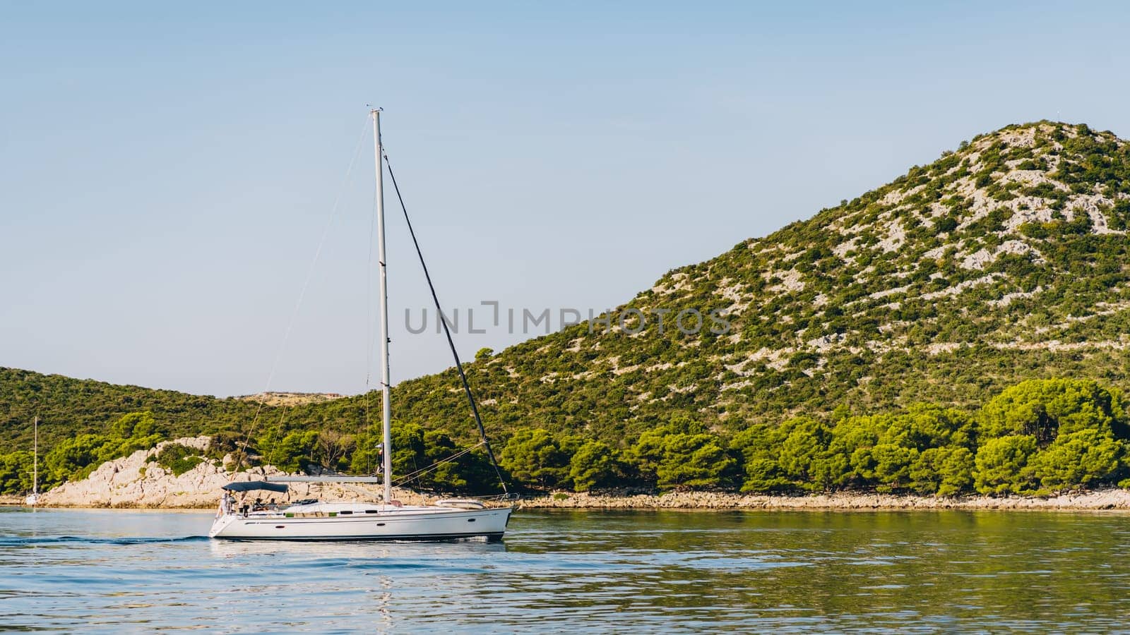Modern yacht with tourists sailing off in Adriatic Sea, Croatia by Popov