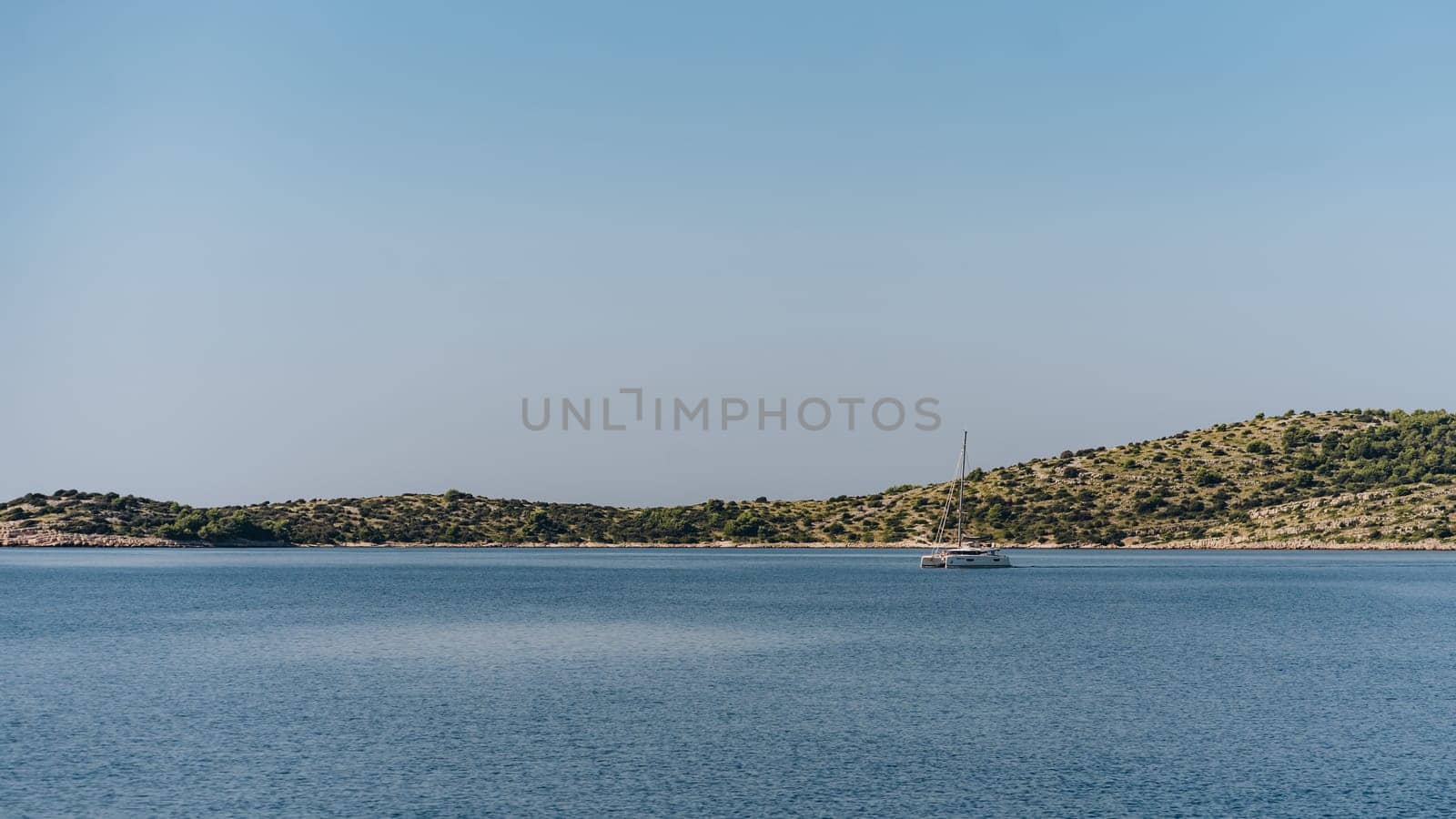 Yacht sailing near shore of Dugi Otok island, Adriatic Sea, Croatia by Popov