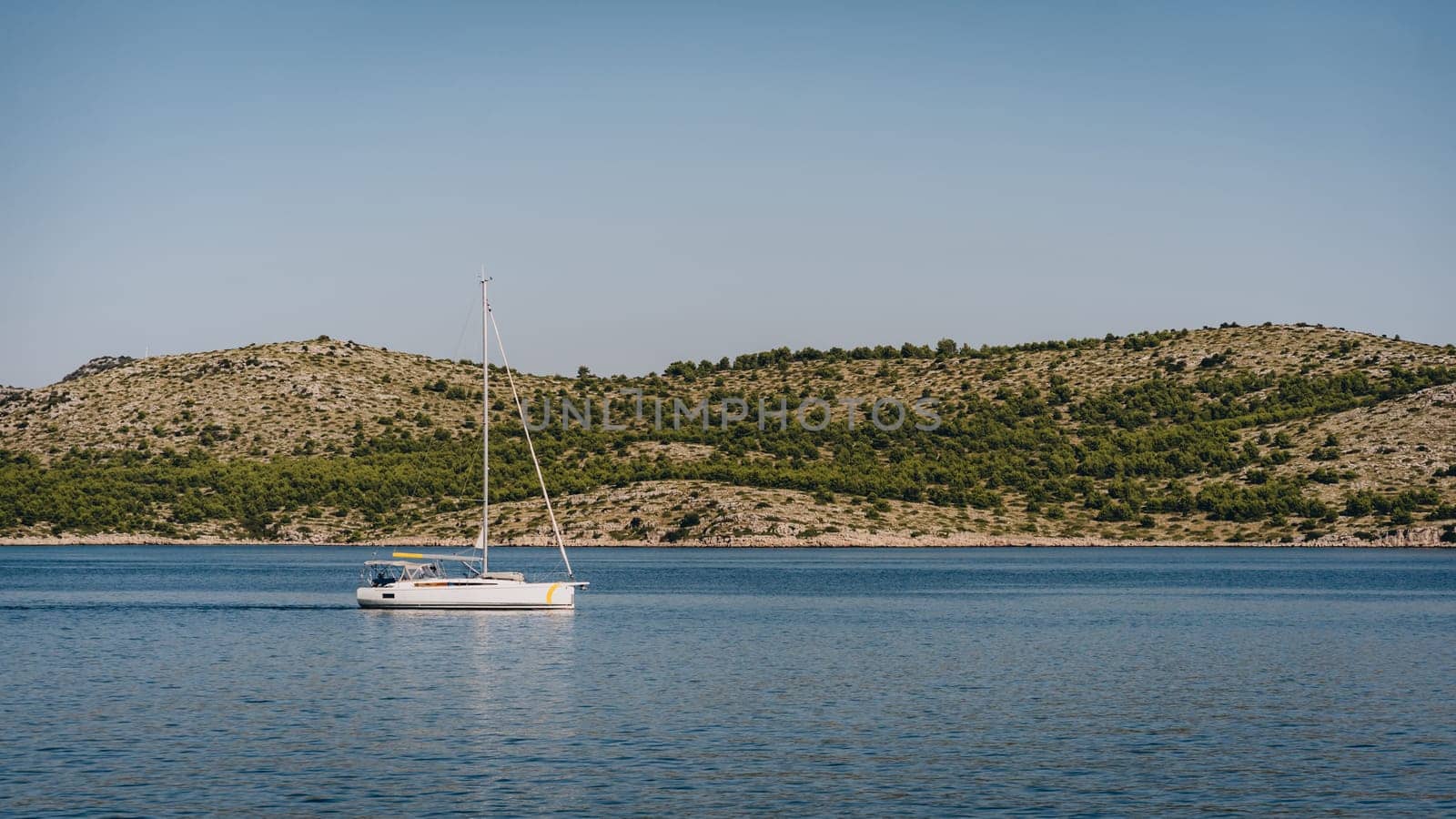 Yacht sailing along coast of Dugi Otok island in Adriatic Sea, Croatia by Popov