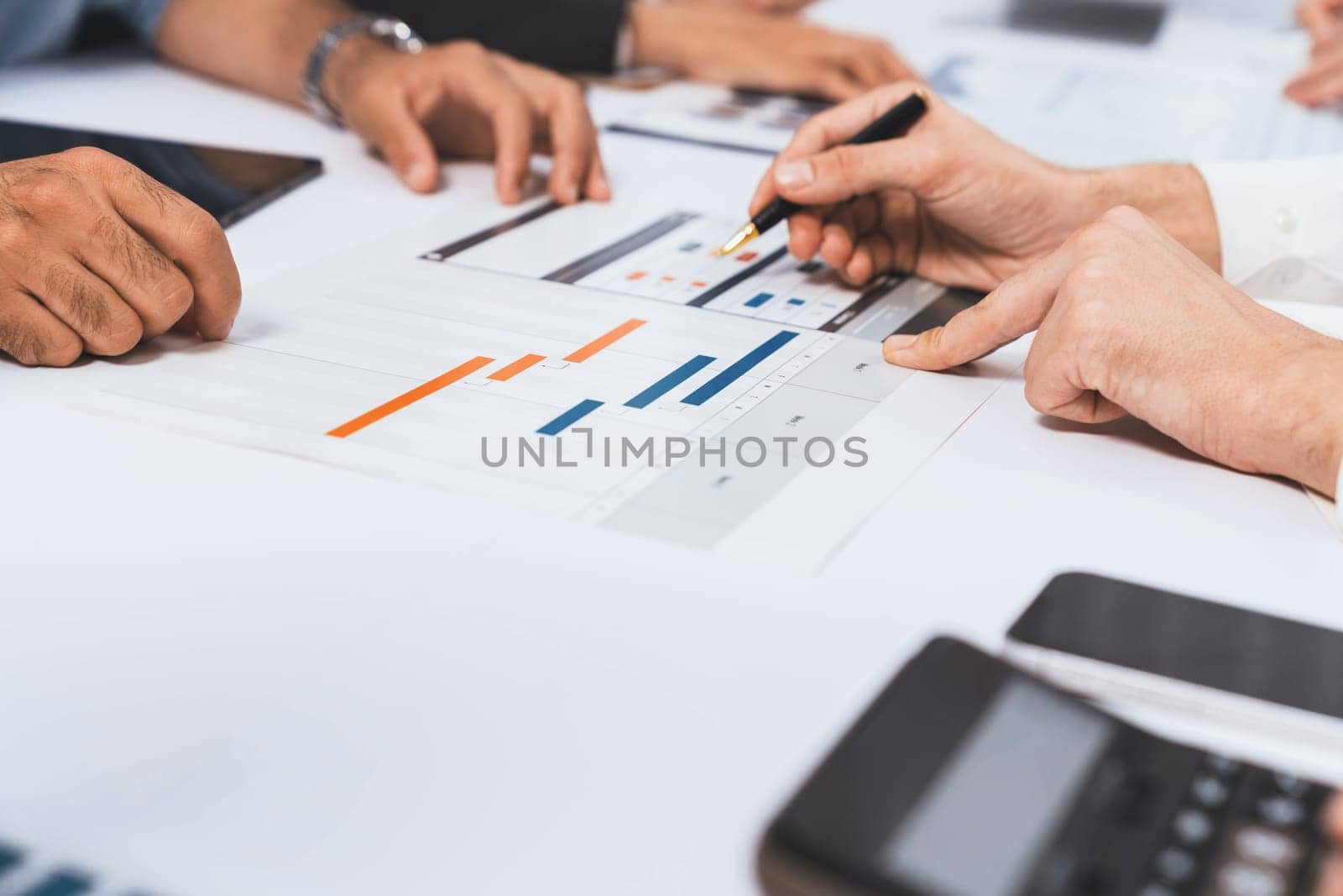 Analyst team utilizing BI Fintech to analyze financial data at table in meeting room. Businesspeople analyzing BI dashboard power on paper for business insight and strategic marketing planning.Prudent