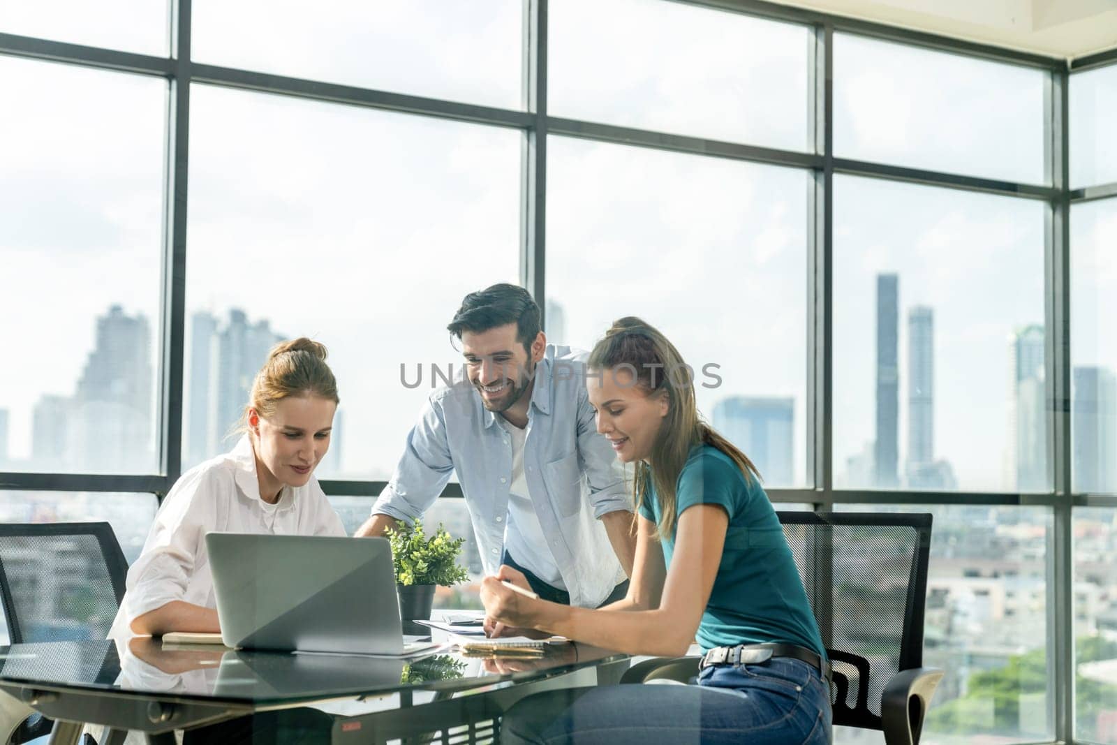 Group of diverse profession business people pointing at laptop displayed idea. Portrait of business team show marketing strategy present by laptop with statistic document scatter on table. Tracery.