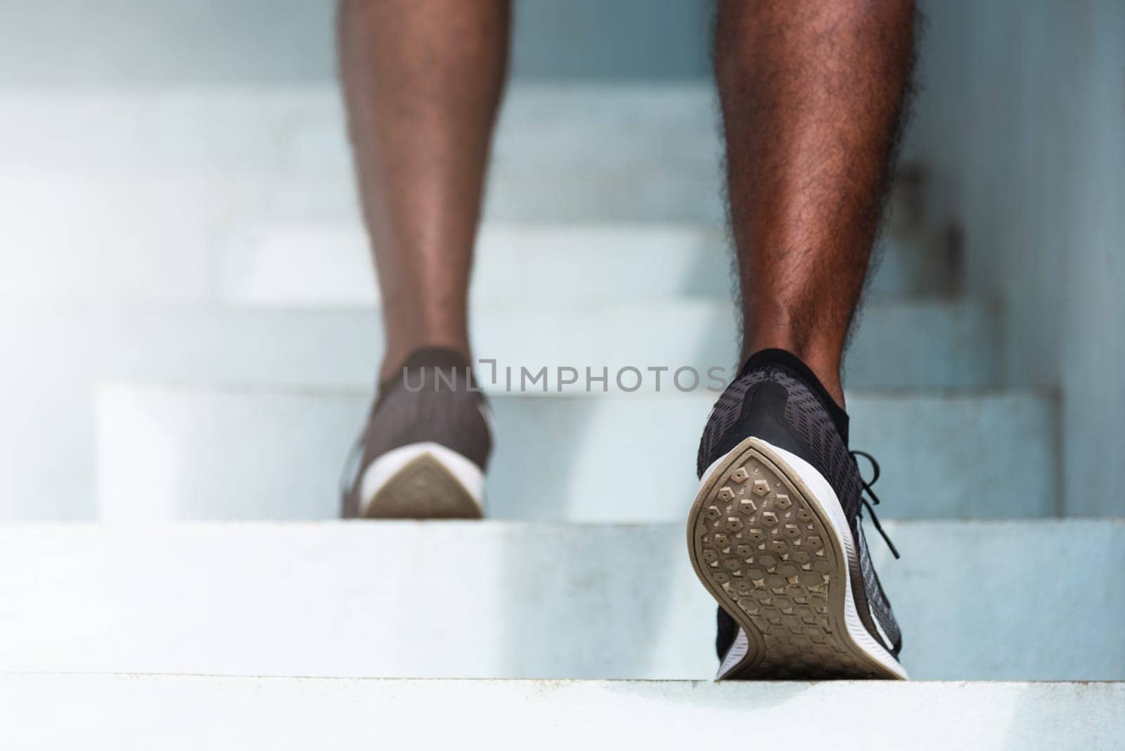 sport runner black man step running up to climbing stairs by Sorapop