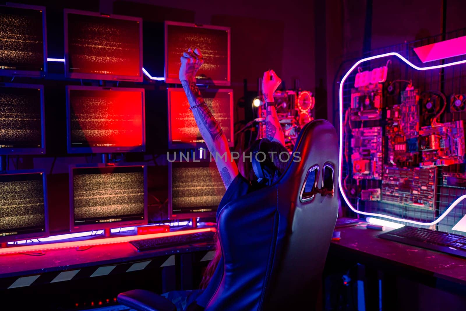 Winning. Happy Gamer young plays online video games computer she raises hands to wins tournament, young woman in gaming headphones playing video game online at home feel excited, E-Sport concept