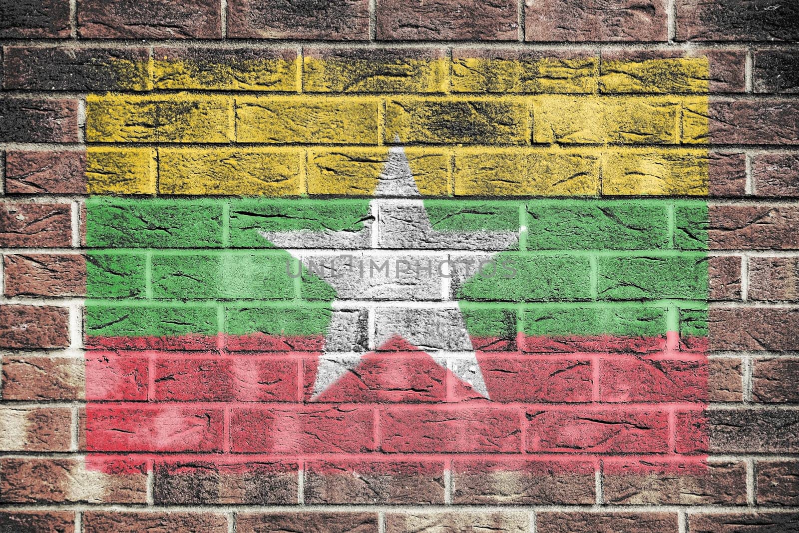 Myanmar flag on old brick wall by VivacityImages