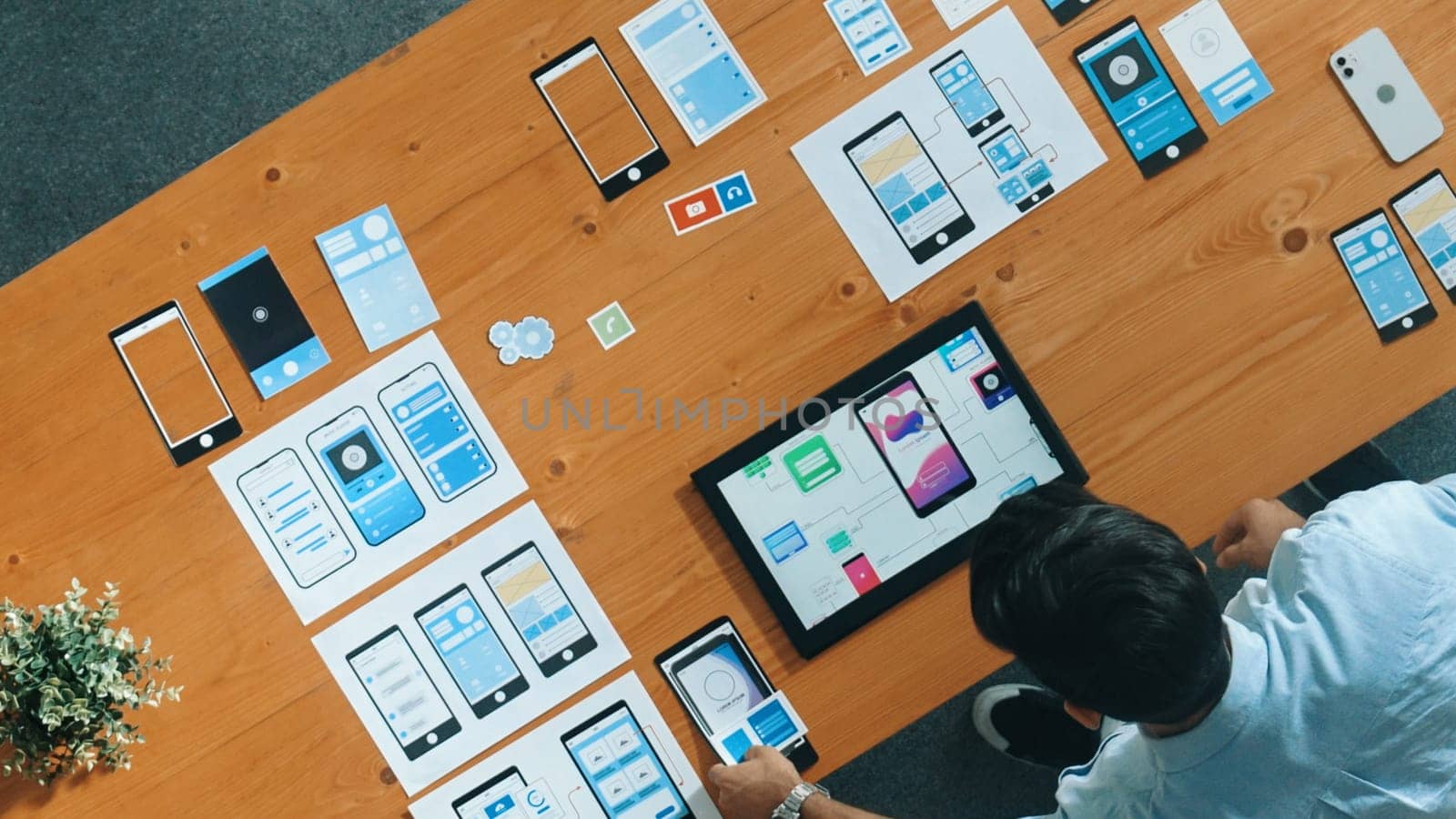 Top view of skilled developer walking and placing Ux Ui software. Smart business man put tablet on meeting table with mobile phone interface or icon. Investor plan develop software plan. Convocation.