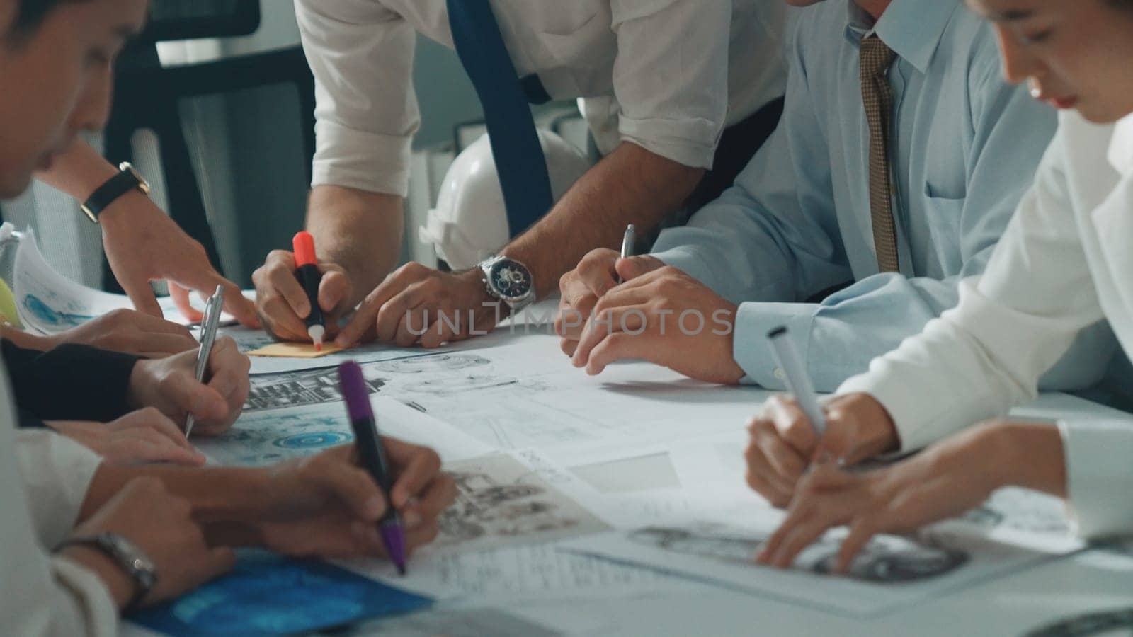 Top view of engineer pointing at turbine engine at meeting table with equipment. Aerial view of professional project manager talking and discussing about electronic generator system. Alimentation.