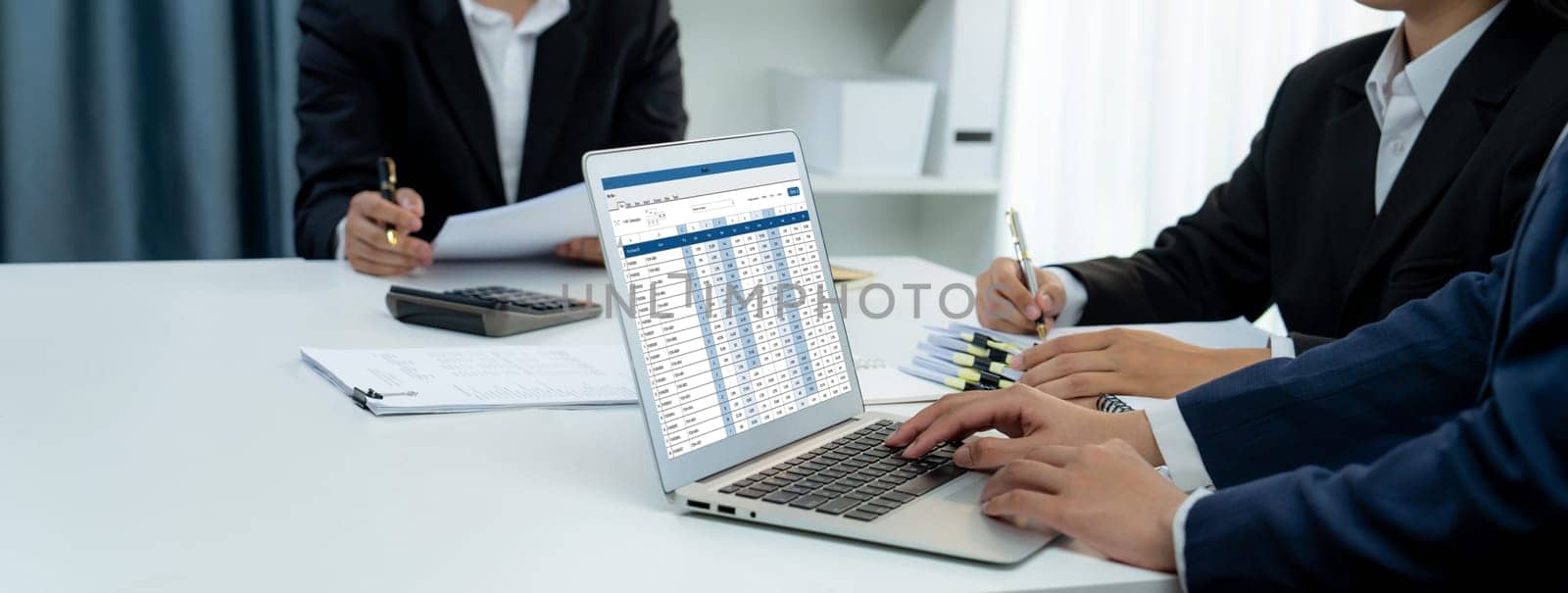 Corporate accountant team use accounting software on laptop to calculate and maximize tax refund and improve financial performance base on financial data. Modern business accounting . Shrewd