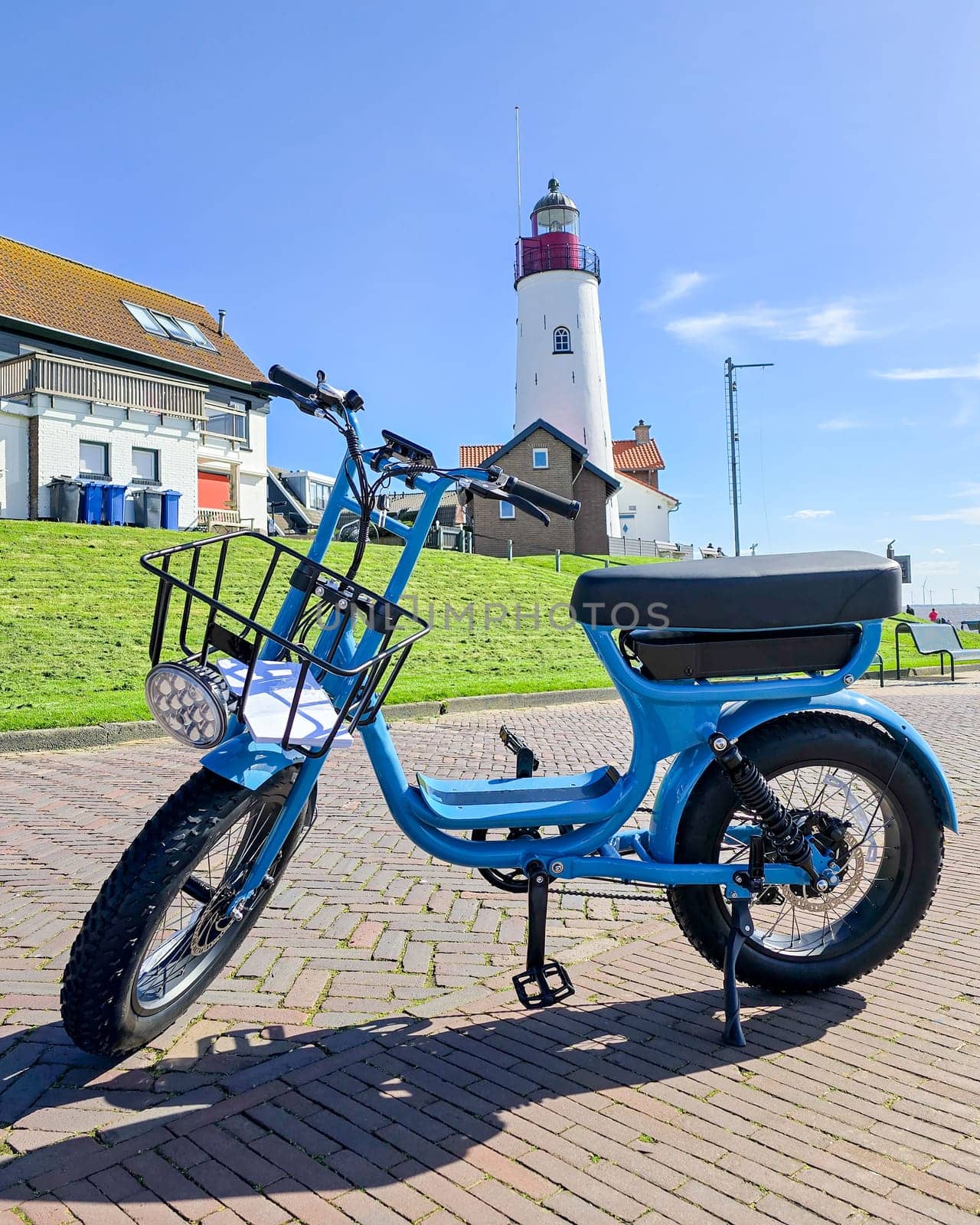 electric green bike bicycle on a beautiful bright day Netherlands Urk, blue electric fatbike by fokkebok