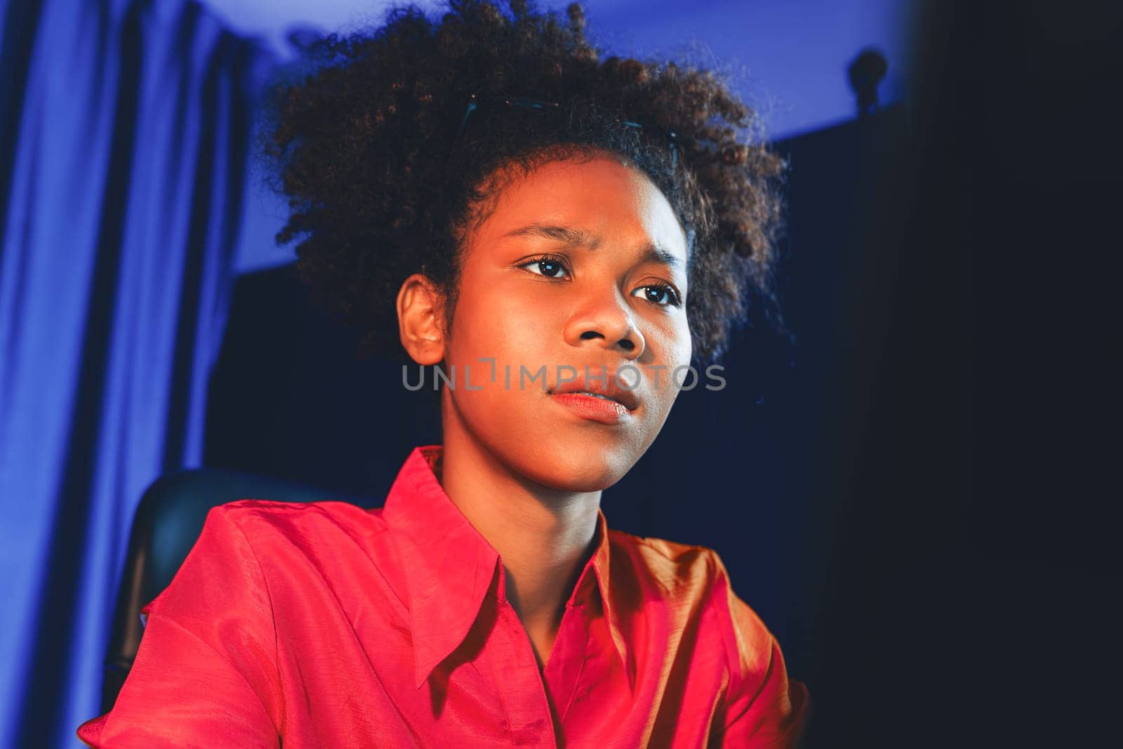 African woman businesswoman or blogger wearing pink shirt with serious face, looking and focusing on screen laptop with struggle project. Concept of stressful expression at work from home. Tastemaker.