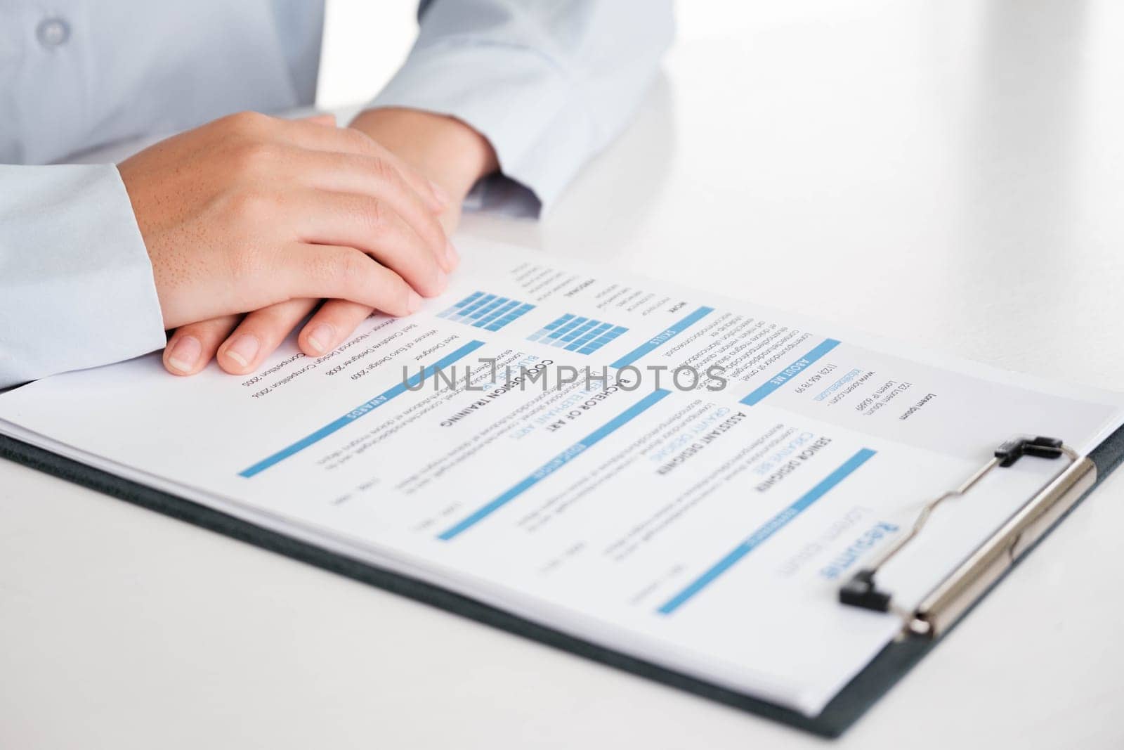 Close-Up of Businessman Holding a Resume. by ijeab