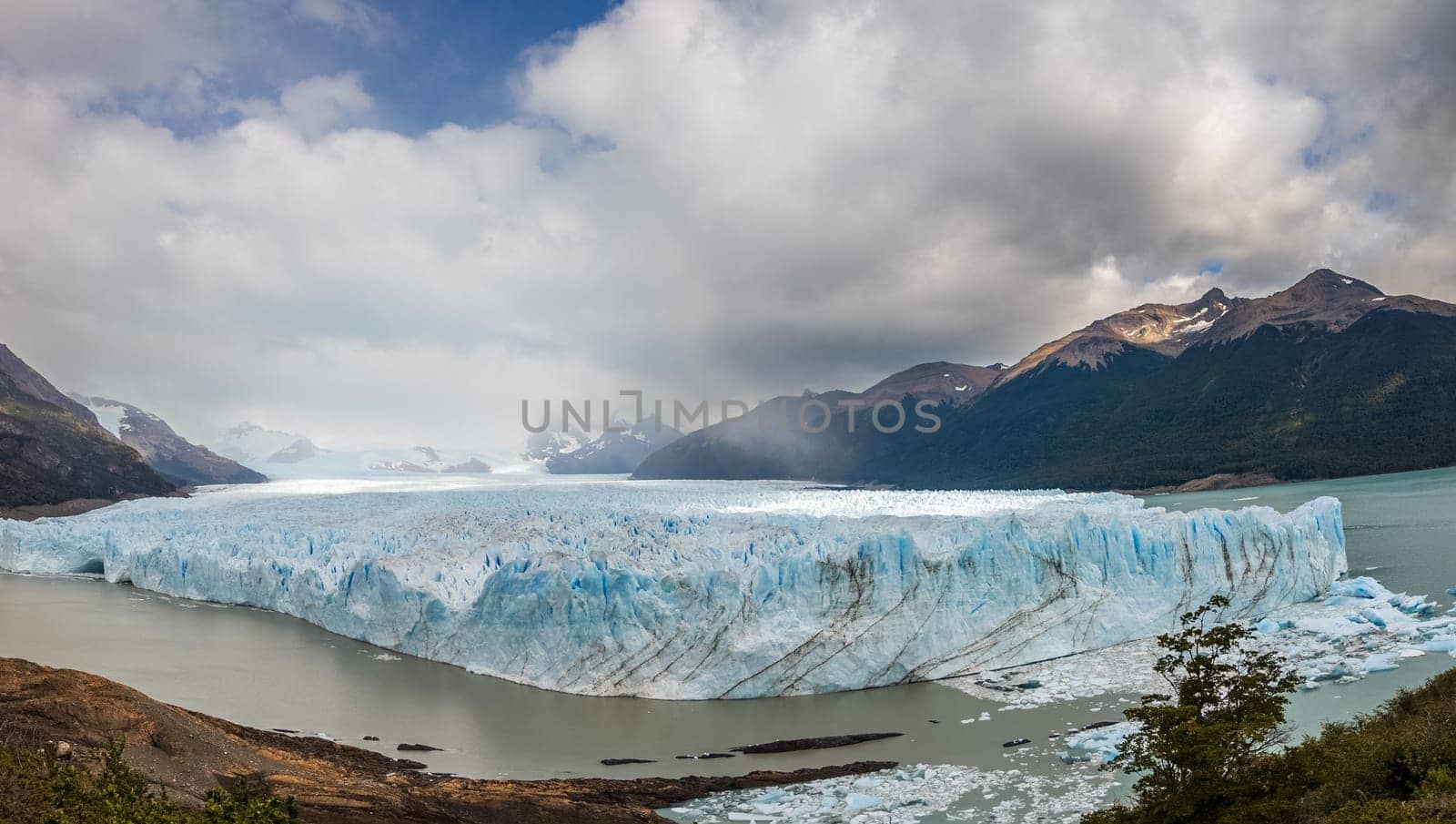 Majestic Glacier View Amidst Mountains and Cloudy Sky by FerradalFCG